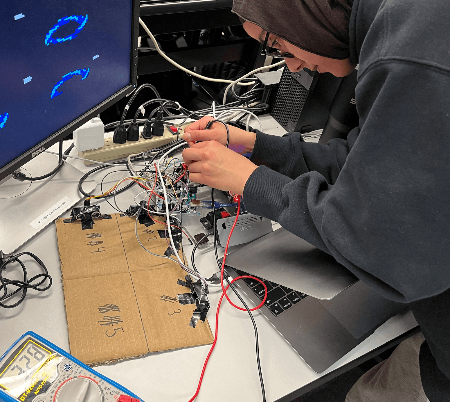 Confirming the NMOS in the level shifter works using a multimeter, and now the FPGA can safely handle 3.3V logic signals instead of 5V.